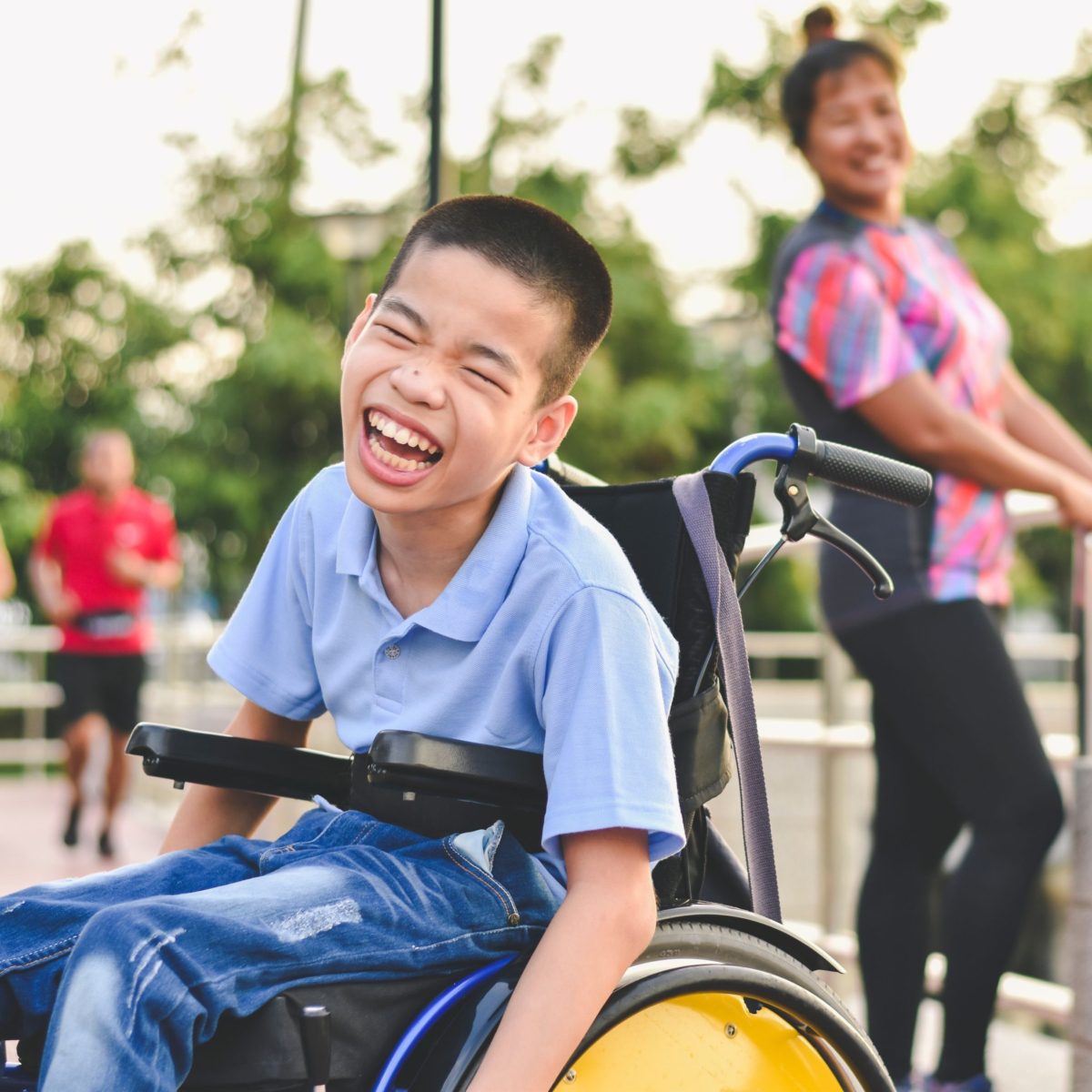 Young boy smiling in wheel chair