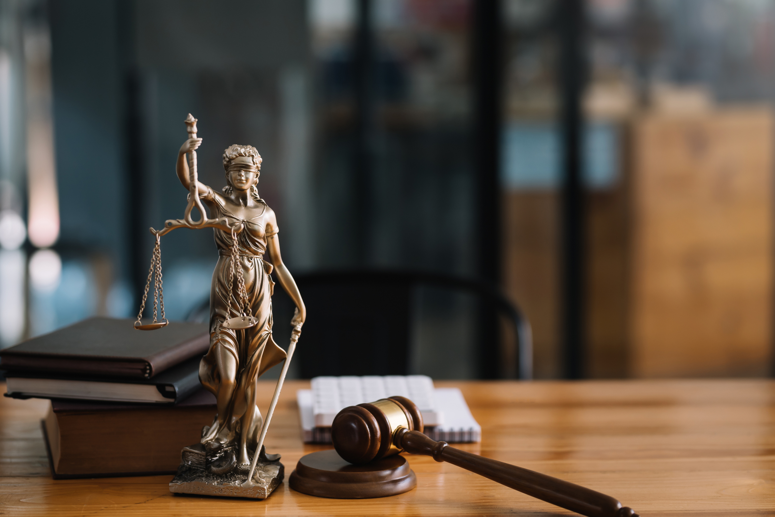 Statue of lady justice on desk of a judge