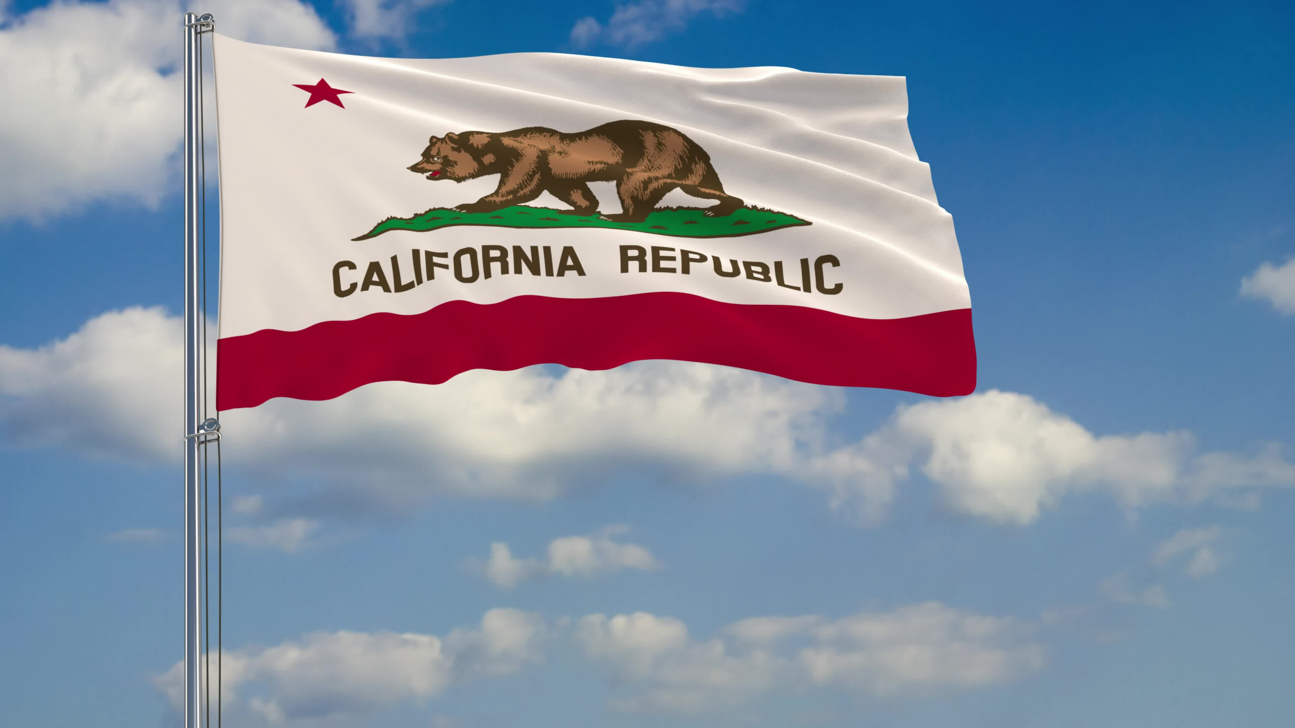 Flag of California - US state fluttering in the wind against a cloudy sky.