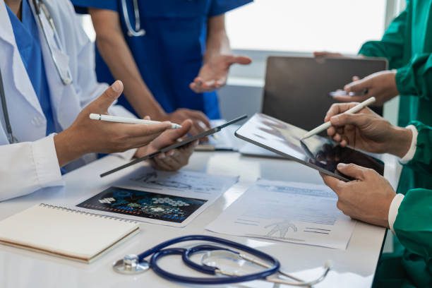 Medical team discussing a patient in a meeting.