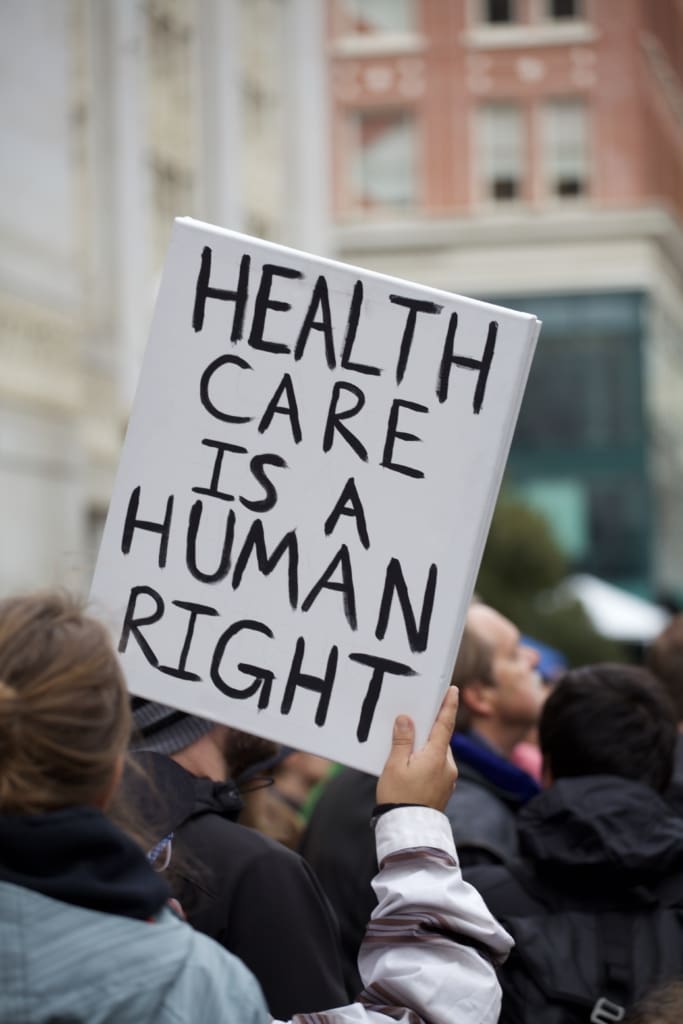 sign that says,, "health care is a human right"